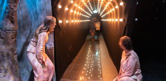 Branar theatre performance - cosmic corridor with 2 people in pink looking through