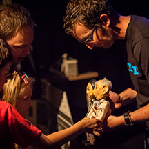 Branar theatre - performer holding puppet with children