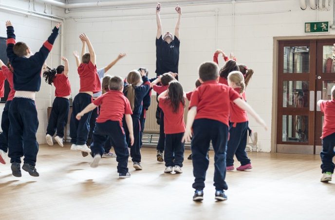 Image: Children jumping with dance teacher - Ballet Ireland