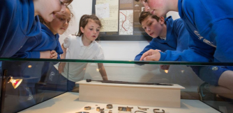 School children examing an exhibit at National Museum of Ireland