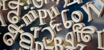 3D magnetic letters are shown on a reflective surface