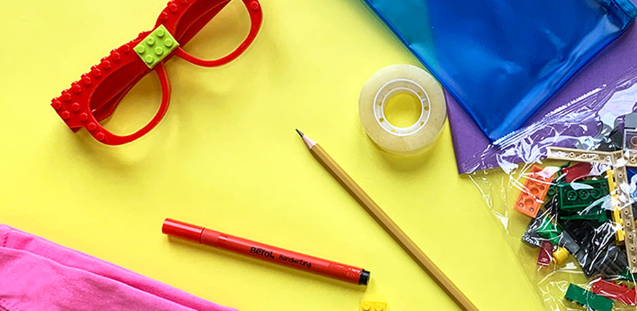 Assorted craft materials displayed on a yellow table surface