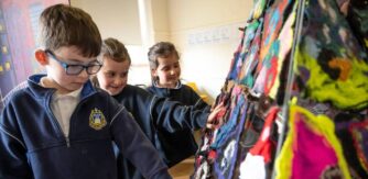 Three Students looking at art piece