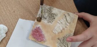 A small hand paints a plaster cast as featured in Dr Jo Lewis guest blog