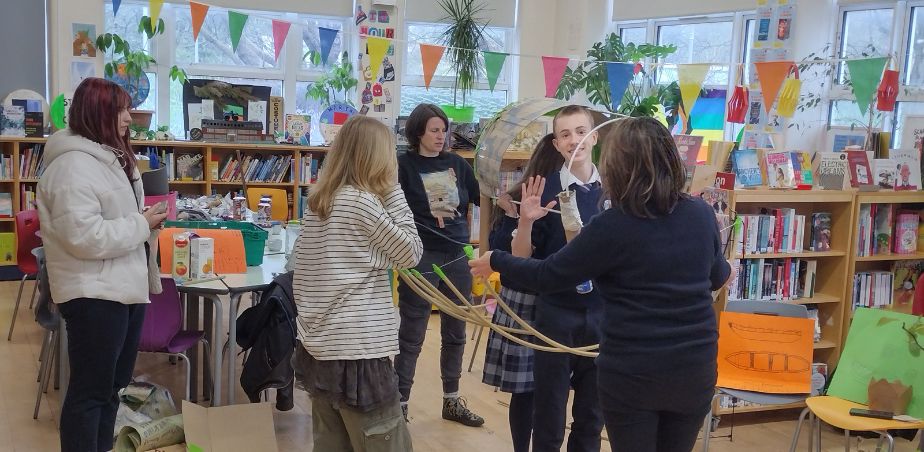 A group of Marino college students in a library making parade props