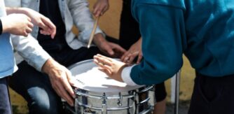 Students play the drums