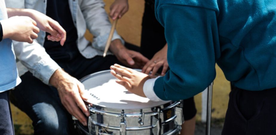 Students play the drums