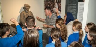 Brendan McGowan, Museum Education Officer sharing the story of Pádraic Ó Conaire with school children visiting the Galway City Museum