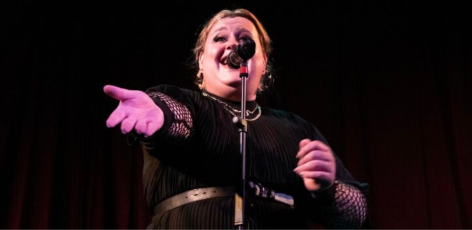 Singer Wren Dennehy sings into a microphone. Wren delivers CPD workshop for teachers at the Ark