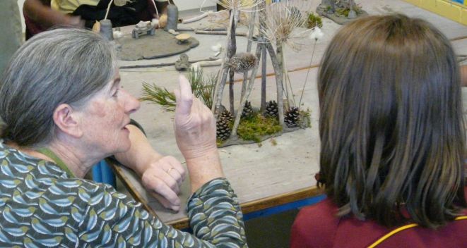 Visual Artist Liz McMahon and a student with a sculpture made from twigs and moss during Creativity in the Classroom
