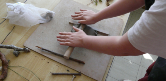 primary student rolling clay for Creativity in the Classroom