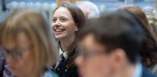 A smiling secondary school student for composers in the classroom