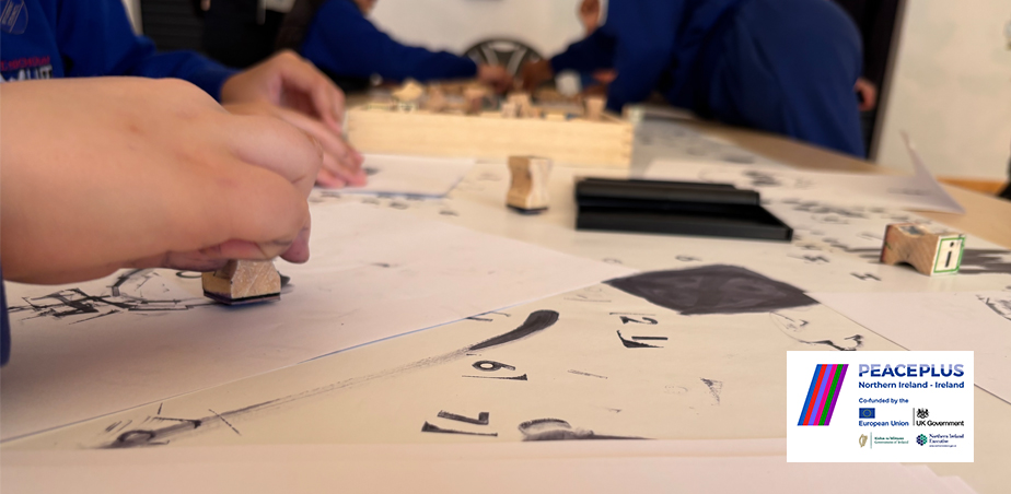 Childs hand makes ink stamping on white paper for COLOUR Project