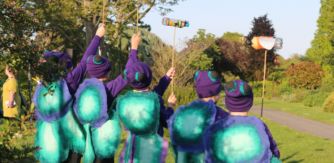 Children dressed as colourful bettles perform for Orpheus in the Garden at National Botanic Gardens