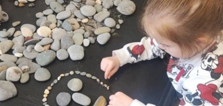 Waves and Wonder. The children making faces with pebbles at Navan Navan Educate Together N.S.