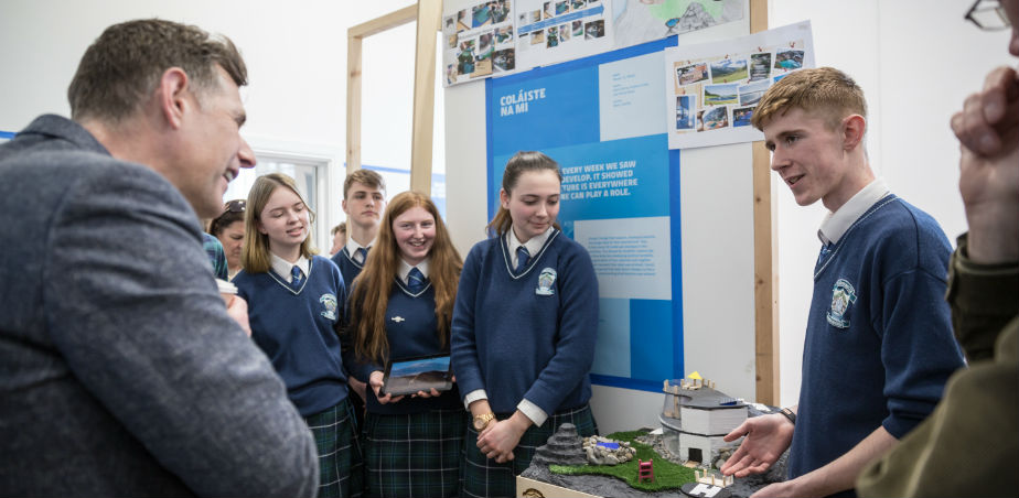 Image: students from Coláiste na Mí presenting their work to architect Dermot Bannon at the Architects in Schools 2018/19 exhibition in GMIT Galway. Photo by Ste Murray